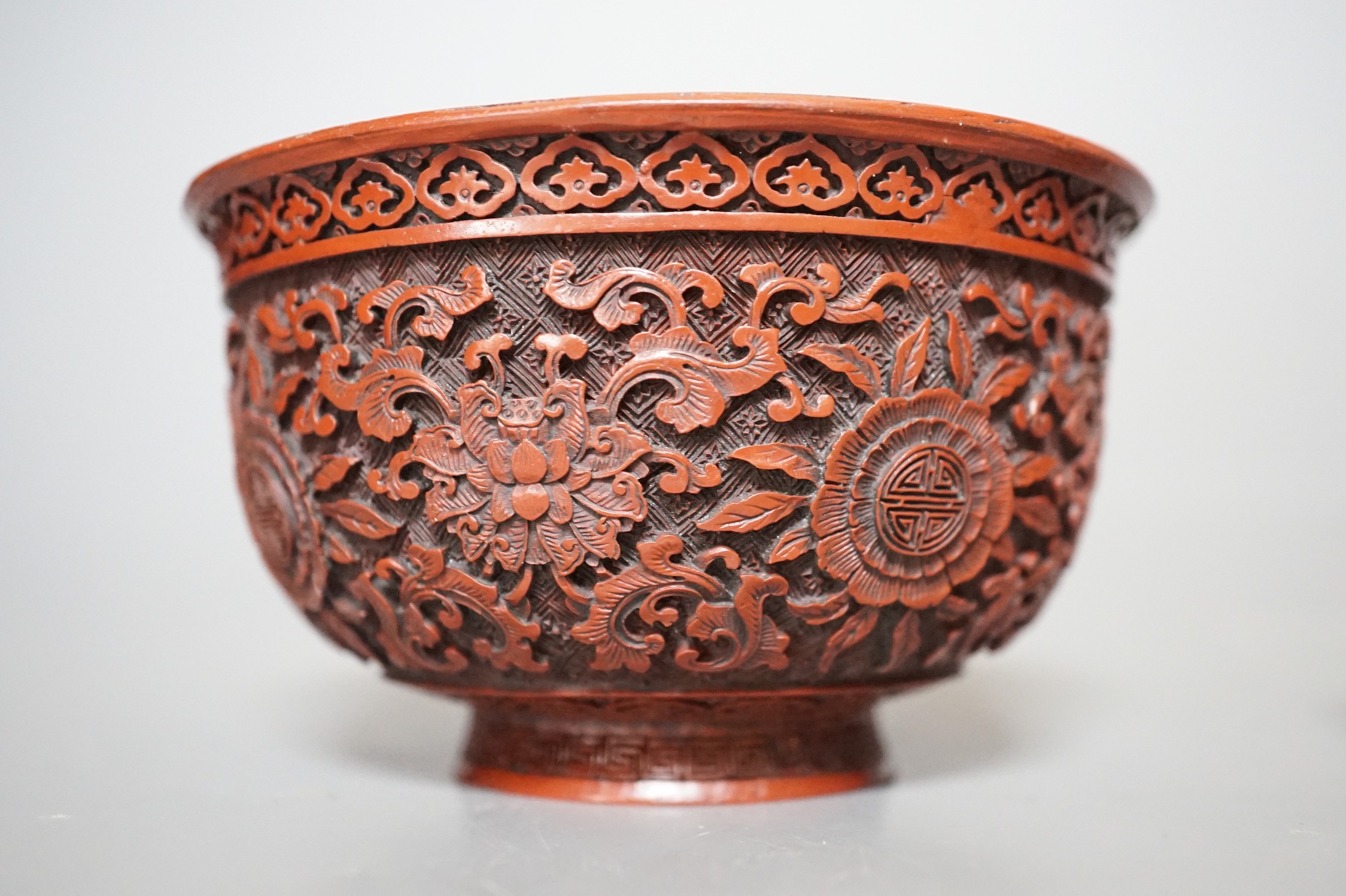 A Chinese painted metal brush rest on stand and a red lacquered bowl, 11cm